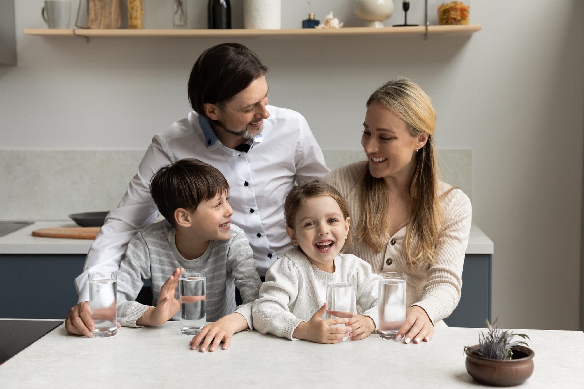 Family together in a kitchen with clean filtered water